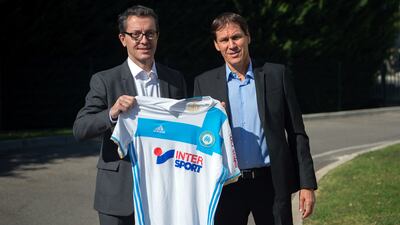 Rudi Garcia and Olympique de Marseille French President Jacques-Henri Eyraud pose with a team jersey as they arrive to take part in a press conference at the club's training centre in Marseille, southern France, on October 21, 2016. AFP