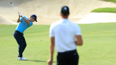 DUBAI, UNITED ARAB EMIRATES - NOVEMBER 16: Chris Paisley of England plays his third shot on the 2nd hole as Henrik Stenson of Sweden looks on during day two of the DP World Tour Championship at Jumeirah Golf Estates on November 16, 2018 in Dubai, United Arab Emirates. (Photo by Andrew Redington/Getty Images)
