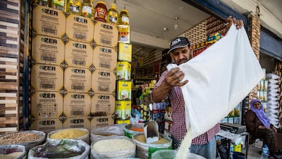 A merchant sells grains at a market in Qamishli, in north-east Syria. AFP