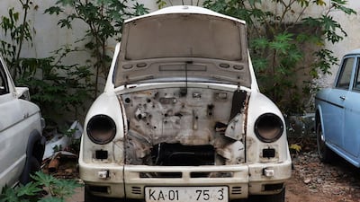 A defunct Ambassador car now a donor of spare parts stands parked at a garage in Bangalore.