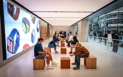 Employees wear protective masks while serving customers at the Apple flagship store in Sydney. Bloomberg
