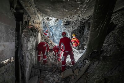 Rescuers search Evin Prison in Tehran following Israeli bombing. AP