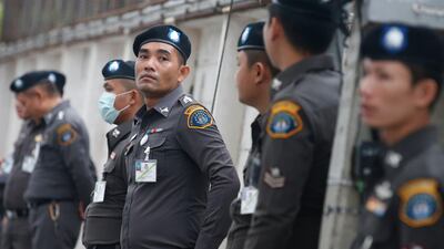 Thai police officers stand guard at the criminal court in Bangkok on Wednesday. EPA / Narong Sangnak