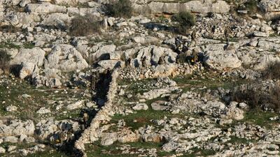 Anti-government fighters take a position near the northern Syrian town of Tal Rifaat. AFP