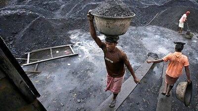 Workers load coal at a depot in Gauhati. Scandal surrounds the sales of India's coal fields. Anupam Nath / AP Photo