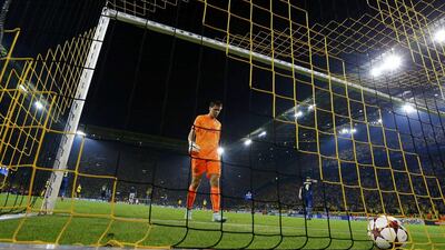 Arsenal goalkeeper Wojciech Szczesny collects the ball from the back of the net after a goal was scored by Borussia Dortmund's Ciro Immobile during their Champions League Group D match on Tuesday. Kai Pfaffenbach / Reuters