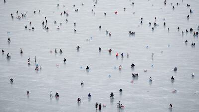 People sledding on a frozen lake near the Summer Palace in Beijing, China. AFP