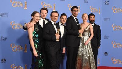 Actors Christian Slater, third from left, and Rami Malek, centre, and other members of the cast and crew of Mr Robot pose with the award for Best TV Series Drama in the press room at the 73rd annual Golden Globe Awards. Frederic J Brown / AFP photo