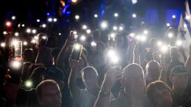 Supporters of the Yashar party led by Gadi Eisenkot, Israel's former military chief of staff, light up their phones as they attend the party's final campaign rally before the legislative election in Tel Aviv. AFP