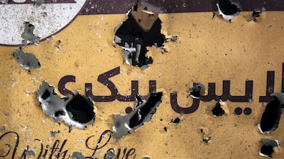 Security forces stand outside Slice Bakery in Share-Naw, where one of the rockets hit, damaging a delivery van and injuring several people. Stefanie Glinski for The National
