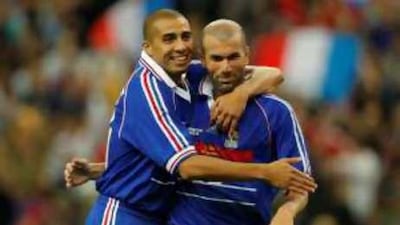 David Trezeguet, left, congratulates his teammate Zinedine Zidane after he scored during the exhibition match between France's 1998 World Cup Champions and a Rest of the World All Star XI.