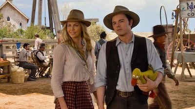 A handout movie still showing Anna (CHARLIZE THERON) and Albert (SETH MACFARLANE) try not to die at the fair in A Million Ways to Die in the West, the new comedy from director, producer and co-writer MacFarlane, who plays a formerly cowardly sheep farmer who must put his newfound courage to the test. (Courtesy: Universal Pictures)