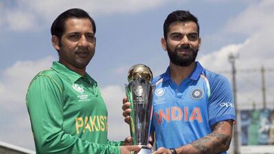 India's captain Virat Kohli, right, and Pakistan's captain Sarfraz Ahmed pose for a picture with the trophy at the Oval cricket ground in London, Saturday June 17, 2017. AP Photo