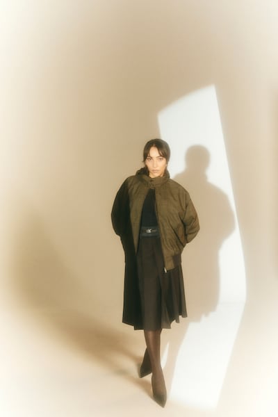 Crew-neck cotton sweater; jacket; skirt; Galleria leather bag; and leather pumps, all from Prada