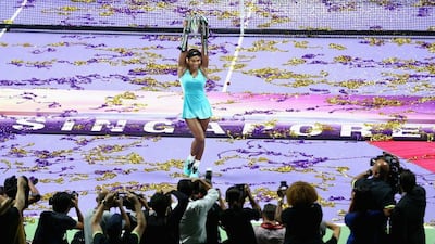 Serena Williams shows off the Billie Jean King trophy after winning the WTA Finals on Sunday in Singapore. Clive Brunskill / Getty Images / October 26, 2014