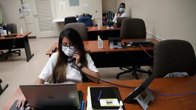 A worker takes a call at the Florida Department of Health in Miami-Dade County, US. AP Photo