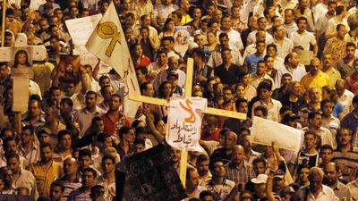 Egyptian Christians march in Cairo during a protest against an attack on a church in southern Egypt , October 9, 2011. Nineteen people were killed in Cairo on Sunday when Christians, some carrying crosses and pictures of Jesus, clashed with military polic???