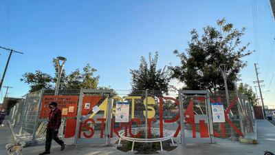 A man wearing a face mask leaves a dog park in the Arts District amid the coronavirus pandemic in Los Angeles, California. AFP