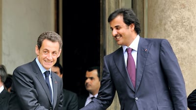 French President Nicolas Sarkozy (L) shakes hand with Qatar Crown Prince Sheikh Tamim Bin Hamad Al Thani (R) on February 3, 2010 at the Elysee Palace in Paris after a working lunch. Eric Feferberg / AFP