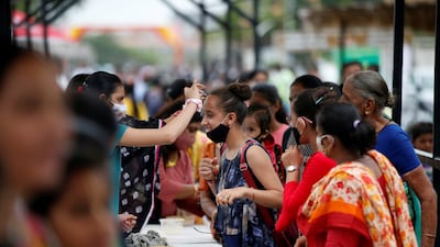 A girl has a tika applied on her forehead during the festival at a temple in Ahmedabad, India. Reuters