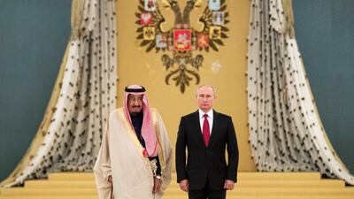 Russian President Vladimir Putin, right, and Saudi King Salman listen to national anthems during their 2017 meeting. The two countries have forged closer ties in the past two years. AP
