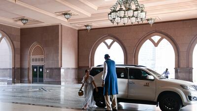 Abdul Jabbar Fazal, 50, who is 2.26m tall and from Lahore, Pakistan, greets guests outside Emirates Palace, Abu Dhabi. Khushnum Bhandari / The National