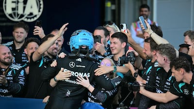 British driver George Russell celebrates with his Mercedes team after winning the Azerbaijan Grand Prix. AFP