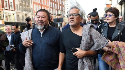 Chinese artist Ai Weiwei, left, walks with British-Indian artist Anish Kapoor, right, during a solidarity for refugees walk through London. Andy Rain / EPA