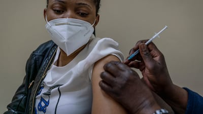 A woman is vaccinated against Covid-19 at the Hillbrow Clinic in Johannesburg, South Africa, on December 6. AP