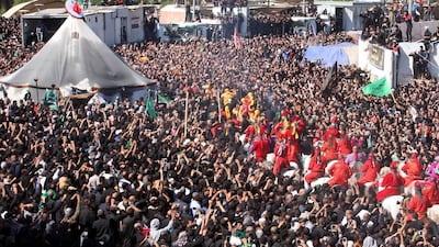 Shiite men take part in the religious ceremony of Ashura in the holy city of Karbala in southern Iraq on November 4, 2014. Alaa Al Shemaree / EPA
