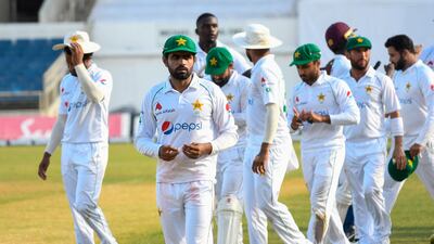 Babar Azam (2L) of Pakistan leads his team off the field at the end of day 4 of the 1st Test between West Indies and Pakistan at Sabina Park, Kingston, Jamaica, on August 15, 2021. (Photo by Randy Brooks / AFP)