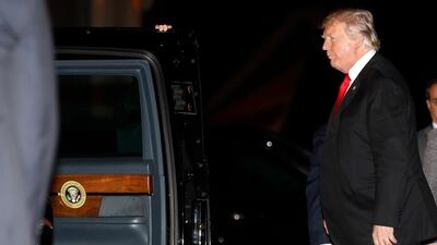 President Donald Trump walks to his motorcade vehicle as he arrives on Air Force One. AP Photo