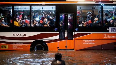 A child swims in the floodwater after heavy rain in Manila, the Philippines. Reuters