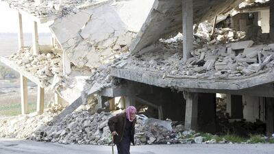 An elderly man walks past a damaged building in the rebel-controlled area of Maaret Al Numan town in Idlib province, Syria, December 21, 2015. Khalil Ashawi / Reuters