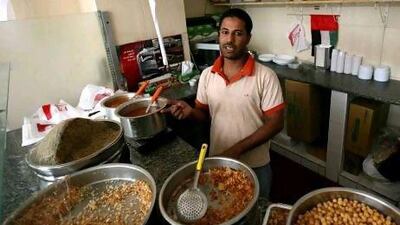 Mohammed Rashad, a 30-year-old Egyptian who works at Lazeez Coshari, a restaurant in Abu Dhabi named for the inexpensive popular vegetarian dish of a similar name, is working to pay for his legal studies with the hope of eventually returning home to work as a lawyer. Fatima Al Marzooqi/ The National