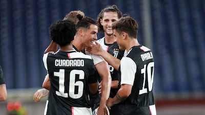 Cristiano Ronaldo, centre, celebrates with teammates after scoring Juventus' second goal against Genoa. AP Photo