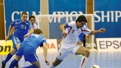 Shamsaee Vahid, the Iran captain and forward, in white, skips past Uzbekistan’s Svirido Konstantin