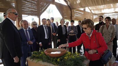 Norway's Queen Sonja makes the sign of the cross. REUTERS