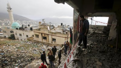 Palestinians inspect the apartment of Rajeb Aliua, a Palestinian held in an Israeli prison, after it was blown up by Israeli troops in the West Bank city of Nablus on December 3. Reuters