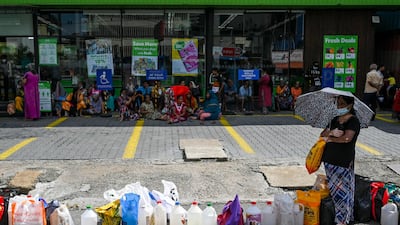 People queue to buy kerosene for domestic use at a supply station in Colombo, Sri Lanka. AFP