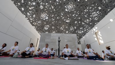 Participants gather under the dome of Louvre Abu Dhabi for a special International Day of Yoga celebration.