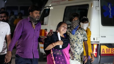 Relatives of a victim of the Morbi bridge collapse mourn. AP