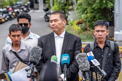 Kunpat Singhathong, centre, is representing three crew members of the Mayuree Naree. AFP