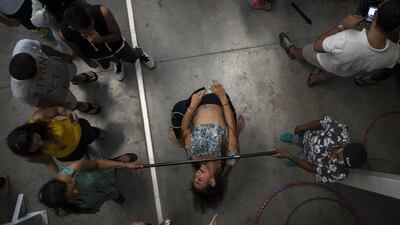 A 'Sunriser' does the Limbo as fellow dancers watch on.