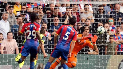 Crystal Palace goalkeeper Vicente Guaita saves a headed chance from Huddersfield Town's Chris Lowe from close range. PA via AP