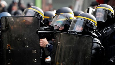 A riot police officer holds a 40-millimetre rubber defensive bullet launcher LBD (LBD40) as he faces off violent protesters. The use of “flash balls” rubber bullets has been controversial given the number of severe injuries they have caused. AFP