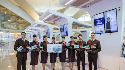 Etihad Airways cabin crew celebrate the launch of Terminal A, which covers 742,000 square metres, at check-in