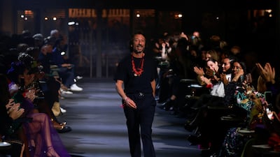 Designer Pierpaolo Piccioli appears at the end of his spring/summer 2022 women's ready-to-wear collection show. Reuters