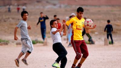 Yemeni youth take part in a football match in their neighbourhood in the capital Sanaa. Mohammed Huwais / AFP