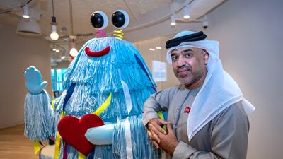Thamer Rasher Al Qasimi, executive director of special projects and partnerships at the Early Childhood Authority, with a colourful office mascot. All photos: Victor Besa / The National
